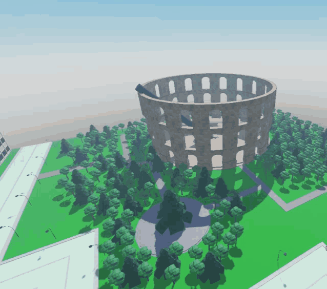 an aerial view of a circular building surrounded by trees and a road