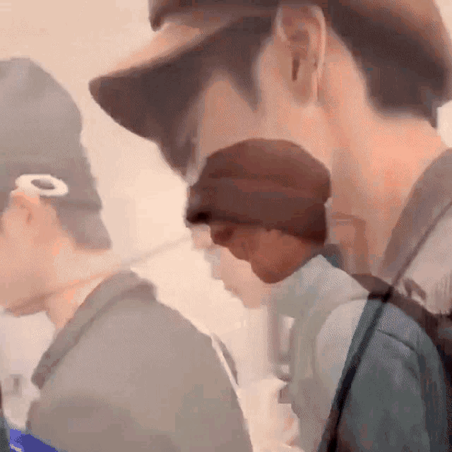 a blurry picture of a man wearing a hat and a backpack