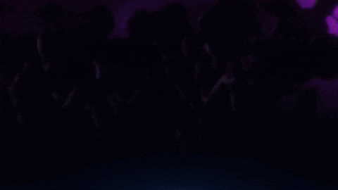 a monster with red eyes is standing in the dark .
