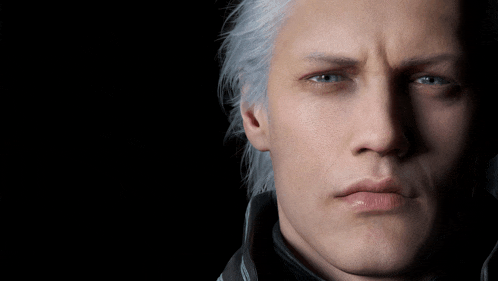 a man with white hair and blue eyes looks at the camera