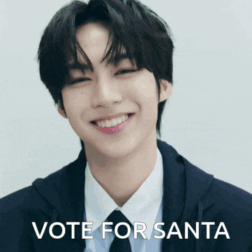 a man in a suit and tie is smiling with the words vote for santa below him