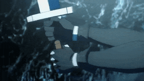 a person is holding a sword in their hands in a cave .