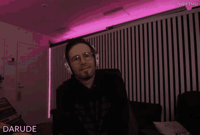 a man making a heart shape with his hands and the name darude on the bottom right