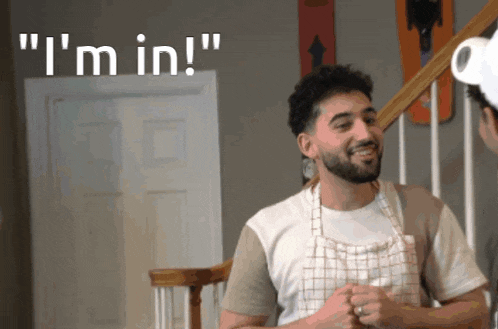 a man wearing an apron says " i 'm in " while talking to another man