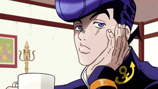 a man in a purple hat is holding a white cup with the number 9 on his collar