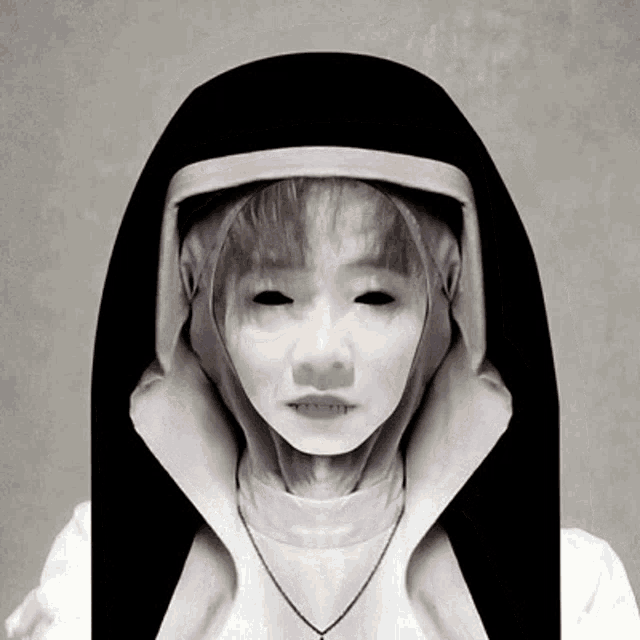 a woman in a nun costume with black eyes and a necklace