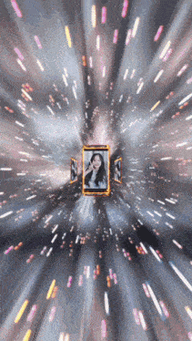 a picture of a woman in a gold frame is surrounded by light