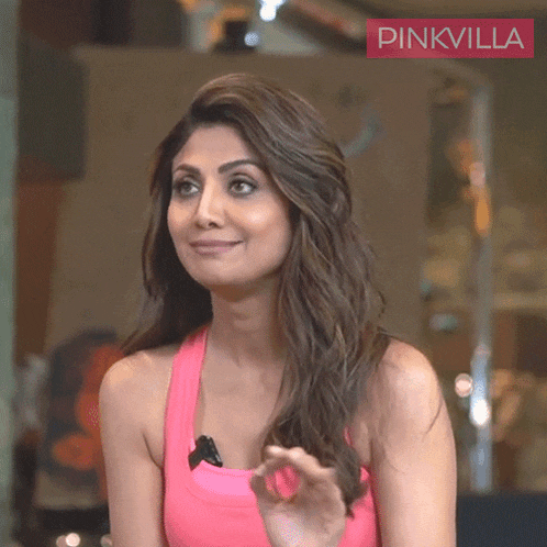 a woman in a pink tank top with the word pinkvilla on the bottom