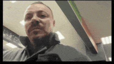 a man with a beard is standing in a store