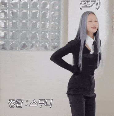 a woman with long gray hair is wearing a black top and tie