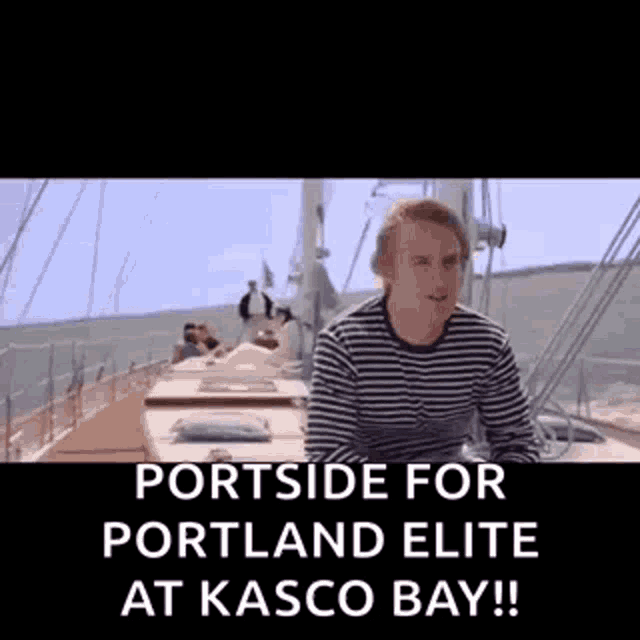 a man is sitting on a boat in the water and says `` portside for portland elite at kasco bay '' .