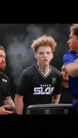 a young man wearing a black shirt that says slam