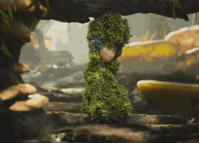 a cartoon character is covered in green moss and leaves