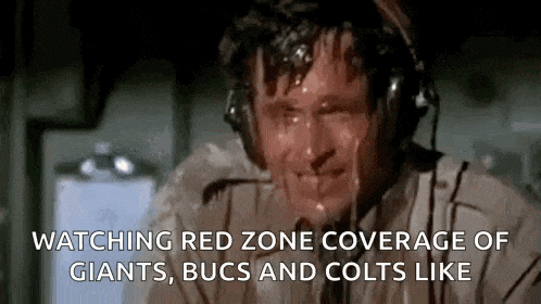 a man wearing headphones is sweating while watching a game between giants , bucs and colts .