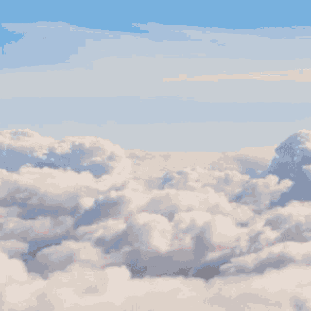 a person wearing headphones and a microphone is in the clouds
