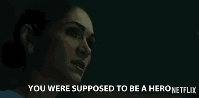 a woman in a dark room with the words you were supposed to be a hero netflix