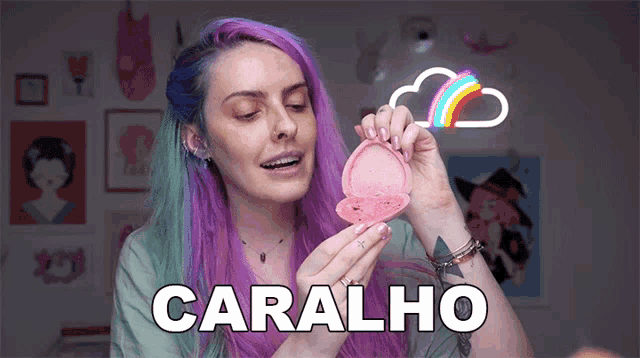 a woman with purple hair is holding a pink object with the word caralho written on it