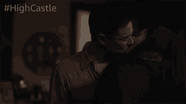 a man and a woman kissing in a dark room with #highcastle written on the bottom