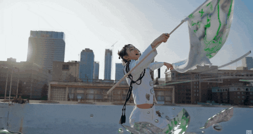 a person holding a flag with a green and white design on it