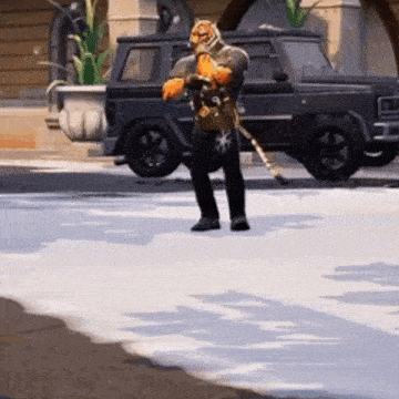 a man in a tiger costume is standing on a snowy street in front of a black suv .
