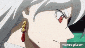 a close up of a person 's face with white hair and red eyes wearing a pair of earrings .