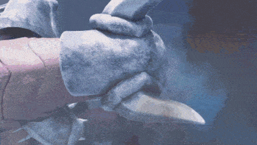 a close up of a person 's hand with a knife in it