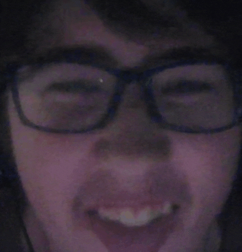 a close up of a person 's face with glasses and headphones .
