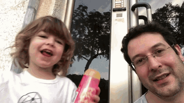 a man and a child are posing for a picture in front of a door