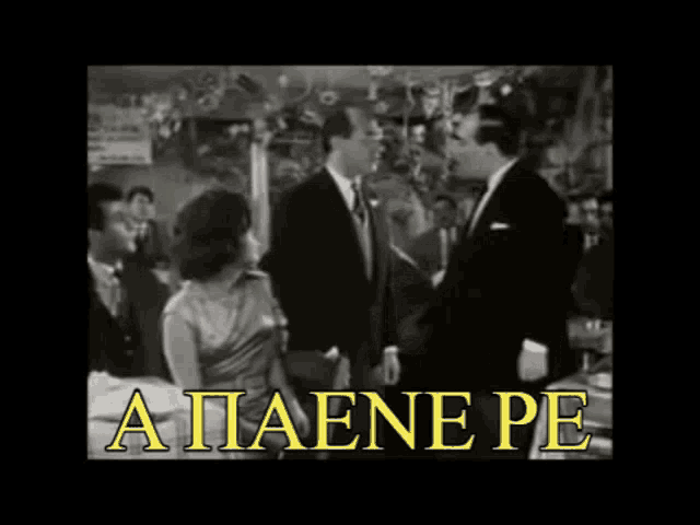 a man in a tuxedo stands in front of a group of people with the words a paene pe on the bottom right