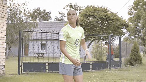 a woman in a yellow vw shirt is running