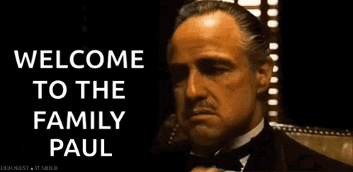 a man in a tuxedo waving his hand with the words welcome to the family paul on the bottom