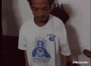 a man is wearing a white shirt with piso on it