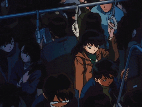 a group of people are riding a bus and one of them is holding onto a railing
