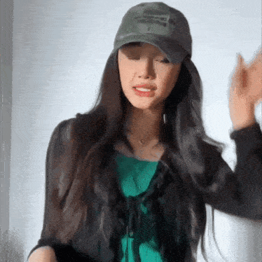 a woman wearing a baseball cap with the word army on it