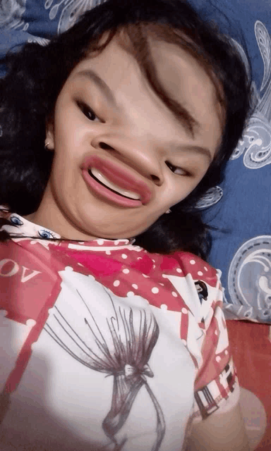a girl wearing a pink and white shirt with the word ov on it