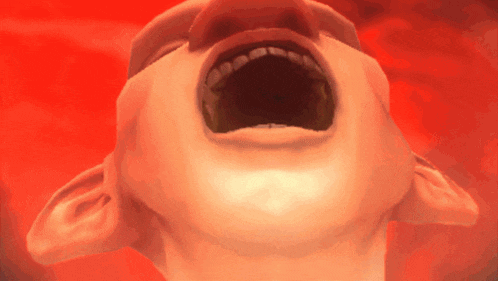 a close up of a man 's face with his mouth open