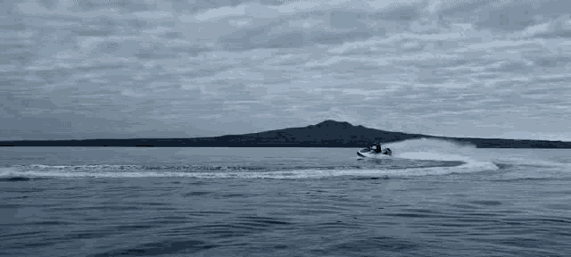 a person is riding a jet ski on top of a body of water .