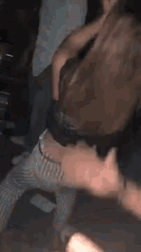a blurry picture of a person laying on the floor with their head in the air .