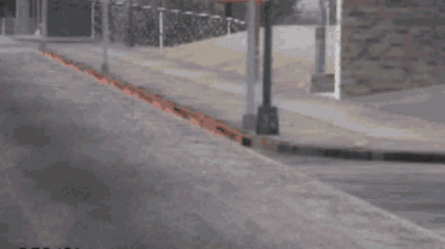 a man walking down a street with haych ( 59 ) in the corner