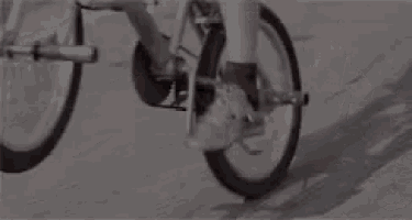 a person is riding a bicycle on a sidewalk