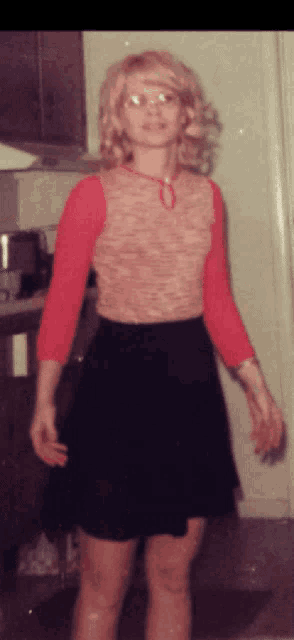 a woman in a red top and black skirt