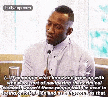 a man is talking into a microphone and saying `` the people who i knew and grew up
