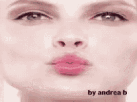 a close up of a woman 's face with her mouth open and her teeth showing .