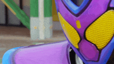 a close up of a purple helmet with a yellow stripe