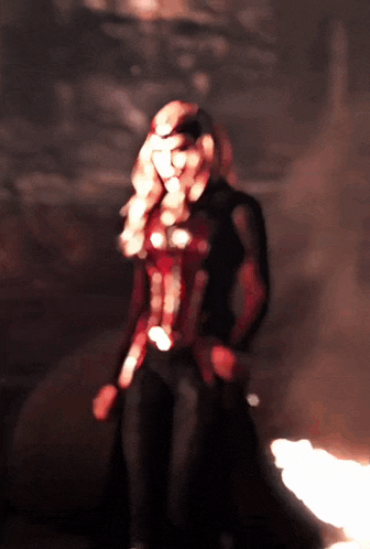 a blurry image of a woman in a red and black outfit