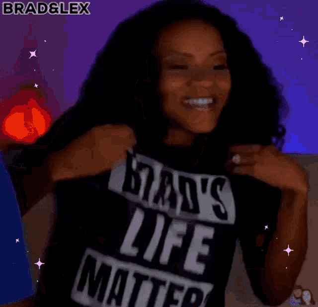 a woman wearing a black t-shirt that says brad 's life matters is sitting on a couch .