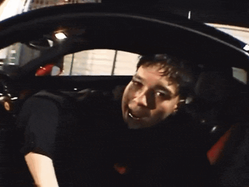 a man in a car with his mouth open