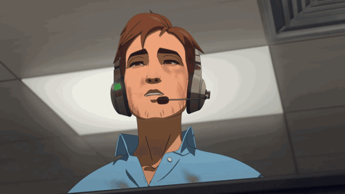 a man wearing headphones and a microphone looks up at something