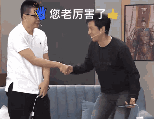a man shaking hands with another man in front of a picture of a man