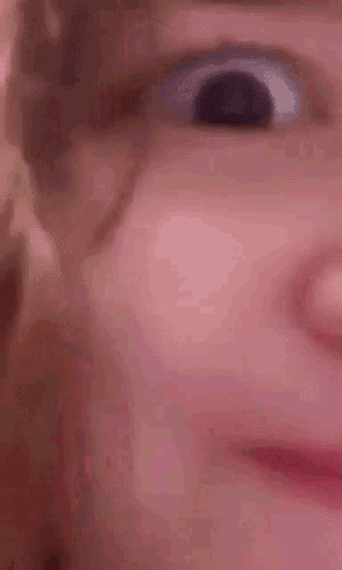 a close up of a person 's face with their eyes closed and their mouth open .